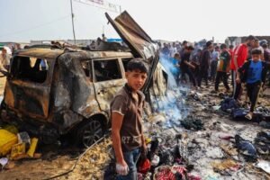 Palestinians gather at the site of an Israeli strike in Rafah.