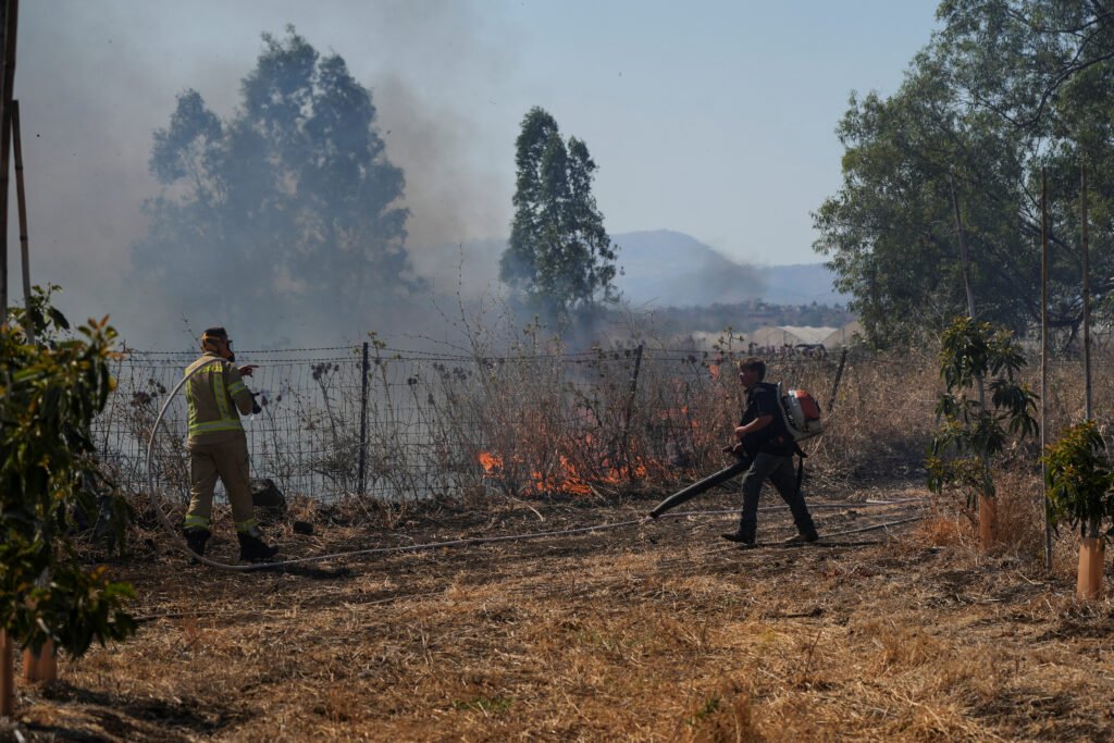 Israeli fire-fighters extinguish a fire